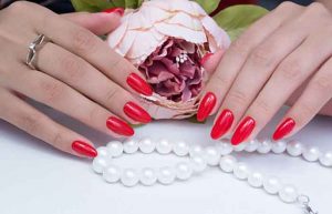 Natural nails with gel polish applied. Ideal manicure and women's hands.