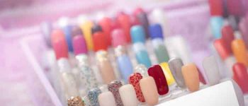 Colorful artificial Nails in nail salon shop. Set of false nails for customer to choose color for manicure or pedicure in nail salon and spa shop. Nails art and design. Sample nail polish palette.